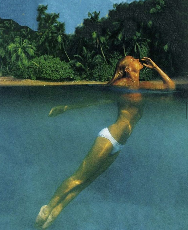 Model swimming in bright blue lagoon image credit @miragemagazine