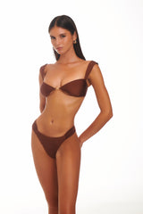 Model wearing a brown lingerie set on a white background